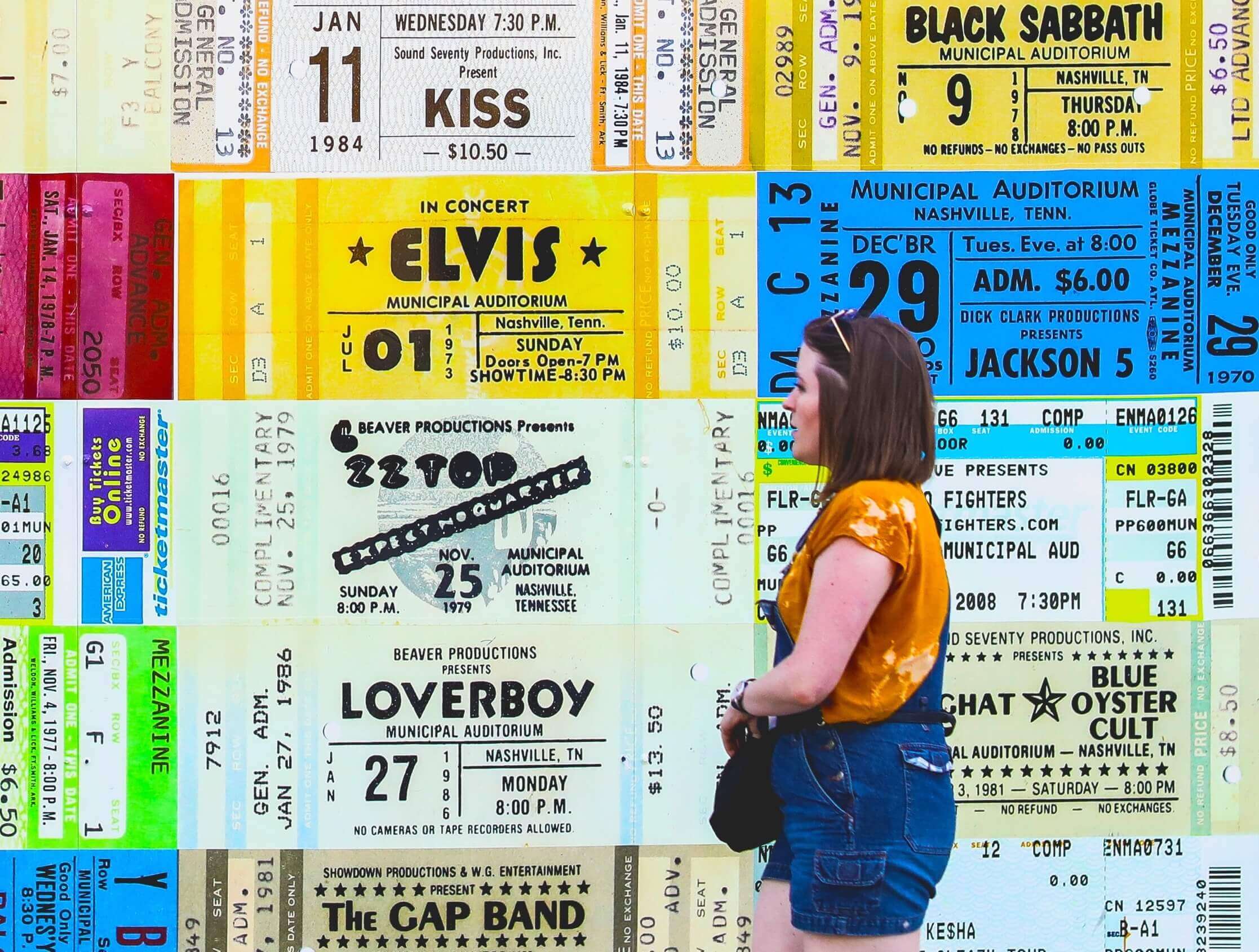 A Woman Looking at Some Concert Posters