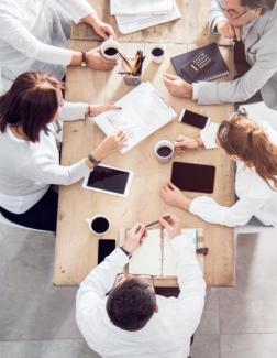 A group of people meeting at an office conference table