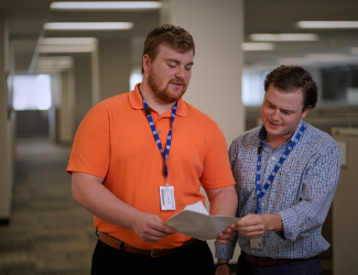 Two people meeting in a hallway